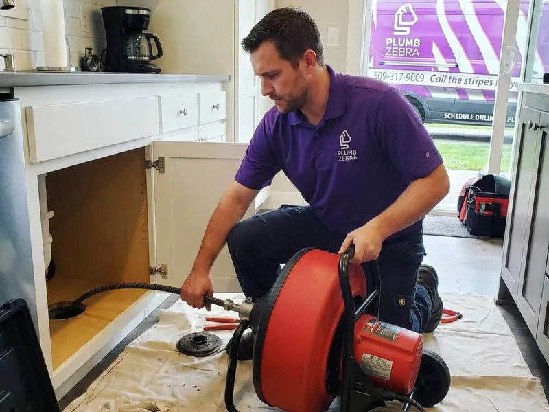 Professional plumber performing drain cleaning & rooter service spokane wa service